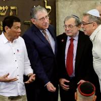 Philippine President Rodrigo Duterte (left) talks with members of the Jewish Association of the Philippines during his visit at the Beit Yaacov Synagogue in Makati city, metro Manila, Tuesday. | REUTERS
