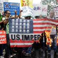 Filipinos protest joint military exercises outside the U.S. Embassy in Manila on Tuesday. | REUTERS