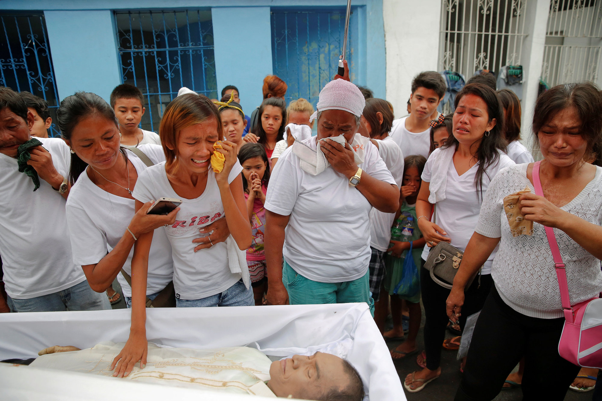 Relatives grieve at the funeral Saturday of Reynaldo Agregado, who was killed in a police anti-drugs operation in Manila. Lawmakers, lawyers and church officials have begun to speak up after more than 3,000 deaths, many of them suspected extrajudicial killings. | REUTERS