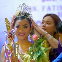 In this handout image, Filipina domestic helper Cyril Goliava (center) is seen in the documentary \"Sunday Beauty Queen\" as she takes part in an annual beauty pageant in Hong Kong. | REUTERS