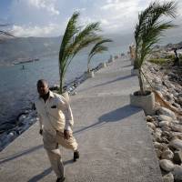 A man walks on a pier in Port-au-Prince Saturday. | REUTERS
