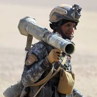 A member of the Iraqi security forces holds a rocket-propelled grenade launcher in the village of Bajwaniyah, about 30 km south of Mosul, on Tuesday amid the forces\' advance to liberate Mosul from the Islamic State group. | AFP-JIJI