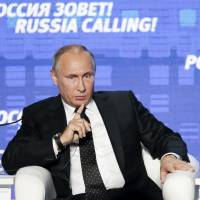 Russian President Vladimir Putin gestures as he speaks at the 8th annual VTB Capital \"Russia Calling!\" Investment Forum in in Moscow on Wednesday. | AP