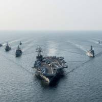 The Yokosuka, Kanagawa Prefecture-based USS Ronald Reagan steams in formation with ships from the U.S. Navy\'s Carrier Strike Group Five and the Republic of Korea\'s Navy during the Invincible Spirit drills in waters off the Korean Peninsula on Friday. | U.S. NAVY