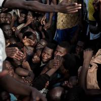 Migrants drift in the Mediterranean some 20 nautical miles north off the coast of Libya on Monday. | AFP-JIJI