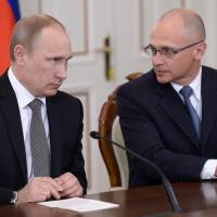 Russian President Vladimir Putin speaks with Rosatom chief Sergei Kiriyenko in the Novo-Ogaryovo residence outside Moscow on Jan. 14, 2014. | AP