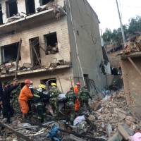 Rescue workers search for survivors following an explosion in the town of Xinmin, in China\'s Shaanxi province, on Monday. | CHINA DAILY / VIA REUTERS
