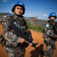 Chinese troops with the United Nations Mission in South Sudan (UNMISS) patrol outside the premises of the U.N. Protection of Civilians site in Juba on Oct. 4. | AFP-JIJI