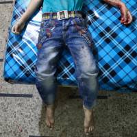 The body of a child is seen at a makeshift hospital following a reported cluster bomb attack on the rebel-held town of Douma, east of the Syrian capital of Damascus, on Monday. | AFP-JIJI