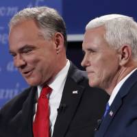 Democratic U.S. vice presidential nominee Tim Kaine (left) and Republican U.S. vice presidential nominee Mike Pence pat each other on the back at the conclusion of their vice presidential debate at Longwood University in Farmville, Virginia, on Tuesday. | REUTERS