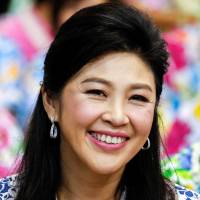 Former Thai Prime Minister Yingluck Shinawatra takes part in Songkran festival celebrations with opposition Puea Thai party members at the party\'s headquarters in Bangkok in April 2016. | REUTERS