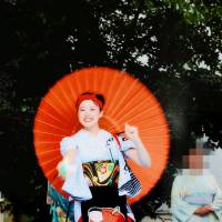 Rima Kasai smiles and dances at the Kuroishi Yosare festival in Aomori Prefecture in this award-winning photo taken Aug. 15. | RIMA KASAI\'S FAMILY / VIA KYODO