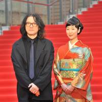 Filmmaker Shunji Iwai and actress Haru Kuroki appear on the red carpet at the Tokyo International Film Festival in the Roppongi district Tuesday. Iwai directed \"A Bride for Rip Van Winkle,\" in which Kuroki starred. | YOSHIAKI MIURA