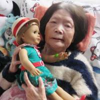 Tsuyako Matsumoto holds a doll sent to her by U.S. Ambassador Caroline Kennedy in Kitami, Hokkaido, in March. | KYODO