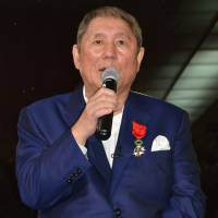 Japanese film director Takeshi Kitano meets with reporters in Paris on Tuesday after he was awarded the title of officer, the fourth degree in the five-ranked Legion of Honor. | KYODO