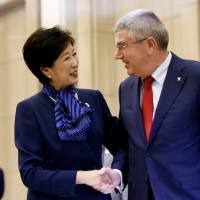 International Olympic Committee President Thomas Bach is greeted by Gov. Yuriko Koike at the Tokyo Metropolitan Government building Tuesday. | REUTERS