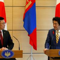 Mongolian Prime Minister Jargaltulga Erdenebat and Prime Minister Shinzo Abe hold a joint news conference in Tokyo on Friday. | REUTERS
