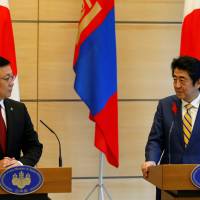 Mongolian Prime Minister Jargaltulga Erdenebat and Prime Minister Shinzo Abe hold a joint news conference in Tokyo on Friday. | REUTERS
