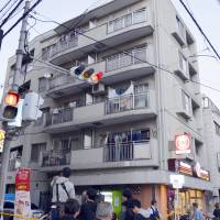 An apartment in Nishiyodogawa Ward, Osaka Prefecture, where a high school student was found dead Monday afternoon, is seen. | KYODO