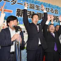Ryuichi Yoneyama (center), a medical doctor who advocates anti-nuclear policies, raises his hands as supporters shout \"banzai\" after he was assured of winning Sunday\'s gubernatorial election in Niigata Prefecture. | KYODO