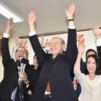 Toyama Gov. Takakazu Ishii celebrates his re-election Sunday night in the city of Toyama. | KYODO