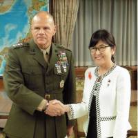 Gen. Robert Neller (left), commandant of the U.S. Marine Corps, and Defense Minister Tomomi Inada shake hands in Tokyo on Wednesday. | KYODO