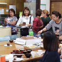 Filipinos get together for lunch after attending Mass at Catholic Koiwa Church in Edogawa Ward, Tokyo, on Sunday. | DAISUKE KIKUCHI