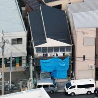 A man was arrested Wednesday on suspicion of breaking into this home in Kadoma, Osaka Prefecture, killing a father and injuring his three children. | KYODO