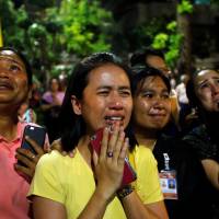 Well-wishers weep outside Siriraj Hospital in Bangkok on Thursday. Thai King Bhumibol Adulyadej passed away there earlier in the day. | REUTERS