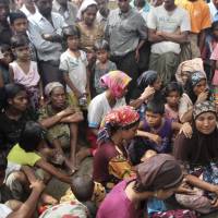 Muslim refugees wait for assistance at a camp in Sittwe, Rakhine state, western Myanmar, in October 2012. | AP