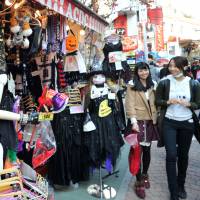 Tokyo tricks: People shop on Takeshita Street in Harajuku last year. | YOSHIAKI MIURA