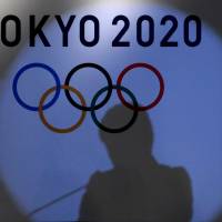 Brought to light: The shadow of Tokyo Gov. Yuriko Koike is seen on the logo of the Tokyo 2020 Olympic Games. Since taking office, Koike has exposed the opaque decision-making and deeply flawed plans behind the Olympics and the Tsukiji fish market relocation. | REUTERS