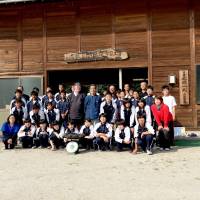 Striking while the iron is hot: C.W. Nicol  poses with Murage Kihara and students from Yokota Middle School at Hitachi Steel Co. in Shimane Prefecture in August. | COURTESY OF C.W. NICOL