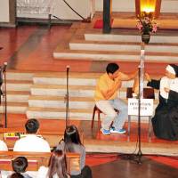 Congregants act out a skit based in a Japanese immigration detention center at this year\'s GFGC event on Oct. 10 at St. Anselm\'s Church in Meguro, Tokyo. | COURTESY OF CARRIE BUCU