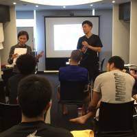 Media trainer Chie Katakami (left), who is helping the B. League establish its rapport with the press, gives pointers to Alvark Tokyo players recently. Katakami preps teams for media