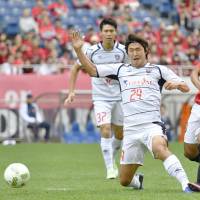 Urawa Reds\' Shinzo Koroki scores a first-half goal against FC Tokyo on Sunday in the League Cup. Urawa beat FC Tokyo 3-1 and advanced to the League Cup final. | KYODO