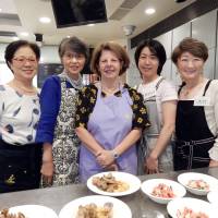 Ilda Esteves (center), the wife of Portugal\'s ambassador, poses with students during a Portuguese culinary lesson at Hattori Nutrition College in Tokyo on Oct. 1. | MAKI-YAMAMOTO-ARAKAWA