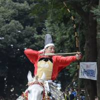 Seto Daiya,  a member of the Japanese swimming team at the Rio Olympic Games,  prepares to shoot an arrow as he rides a horse during a traditional yabusame archery event in his hometown of Moroyama, Saitama Prefecture, on Sunday. | KYODO