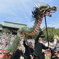 Dragon dancers perform during the traditional Nagasaki Kunchi autumn festival, which attracted about 3,000 visitors on Friday. The 380-year-old festival in the city of Nagasaki runs through Sunday. | KYODO