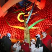 People look around the inside of the Tower of the Sun, created by late artist Taro Okamoto as the symbol of Expo \'70  in Osaka, during a prerenovation showing in Suita, Osaka Prefecture, on Saturday. They were among 1,300 applicants chosen by lottery to view the piece before repairs begin. | KYODO