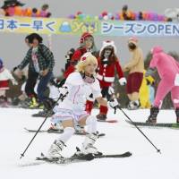 Costumed skiers hit the slopes at Snowtown Yeti at the foot of Mount Fuji in Susono, Shizuoka Prefecture, on Friday. The ski resort was the first to open for the season, and those who dressed up for Halloween got in for free. | KYODO