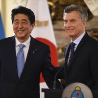 Prime Minister Shinzo Abe poses with Argentine President Mauricio Macri during a news conference in Buenos Aires on Monday. Japan, Argentina vow to speed up talks on investment pact