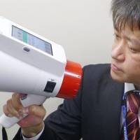 Panasonic Corp.\'s new megaphone features automatic translation of Japanese into English, Chinese and Korean. | KYODO