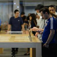 Shoppers try out Apple Inc.’s iPhone 7 smartphones at the company’s store in Tokyo’s Ginza district on Sept. 27. Apple wants OLED displays in next iPhone iteration but most suppliers aren't ready