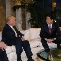 Prime Minister Shinzo Abe meets with U.S. President-elect Donald Trump at Trump Tower in New York on Thursday. Abe wooed Trump with golf, just like his grandfather did with Eisenhower