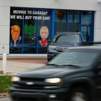 A painted sign in the window of a Honda dealership in Detroit shows the frustration of voters who did not support Donald Trump. | AFP-JIJI