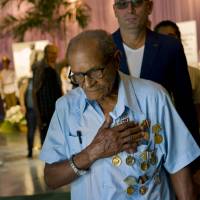 An elderly man wearing military medals holds his hand over his heart after paying his final respects to the late Fidel Castro in Havana Monday. Thousands of Cubans began lining up early for the start of week-long services bidding farewell to the man who ruled the country for nearly half a century. | AP