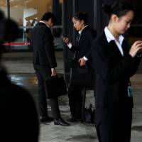 People check their phones during the third annual World Internet Conference in Wuzhen, China, on Thursday. | REUTERS