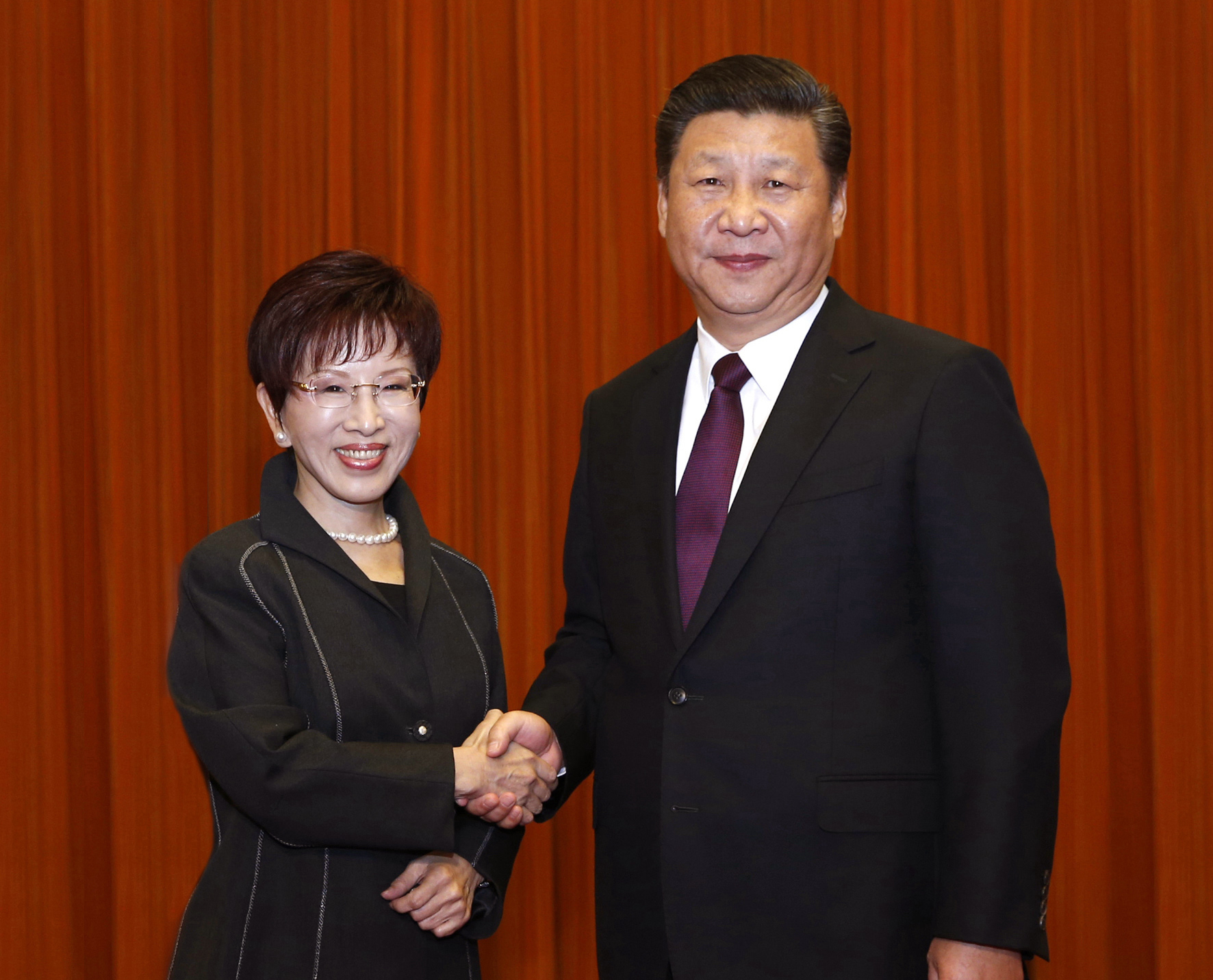 Chinese President Xi Jinping and Kuomintang Chairwoman Hung Hsiu-chu shake hands as they pose for photographers during a meeting at the Great Hall of the People in Beijing on Tuesday. | AP