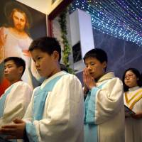 Young Chinese worshippers attend a Christmas Eve Mass last year at a Catholic church in Beijing. China priests wary of Vatican's olive branch
